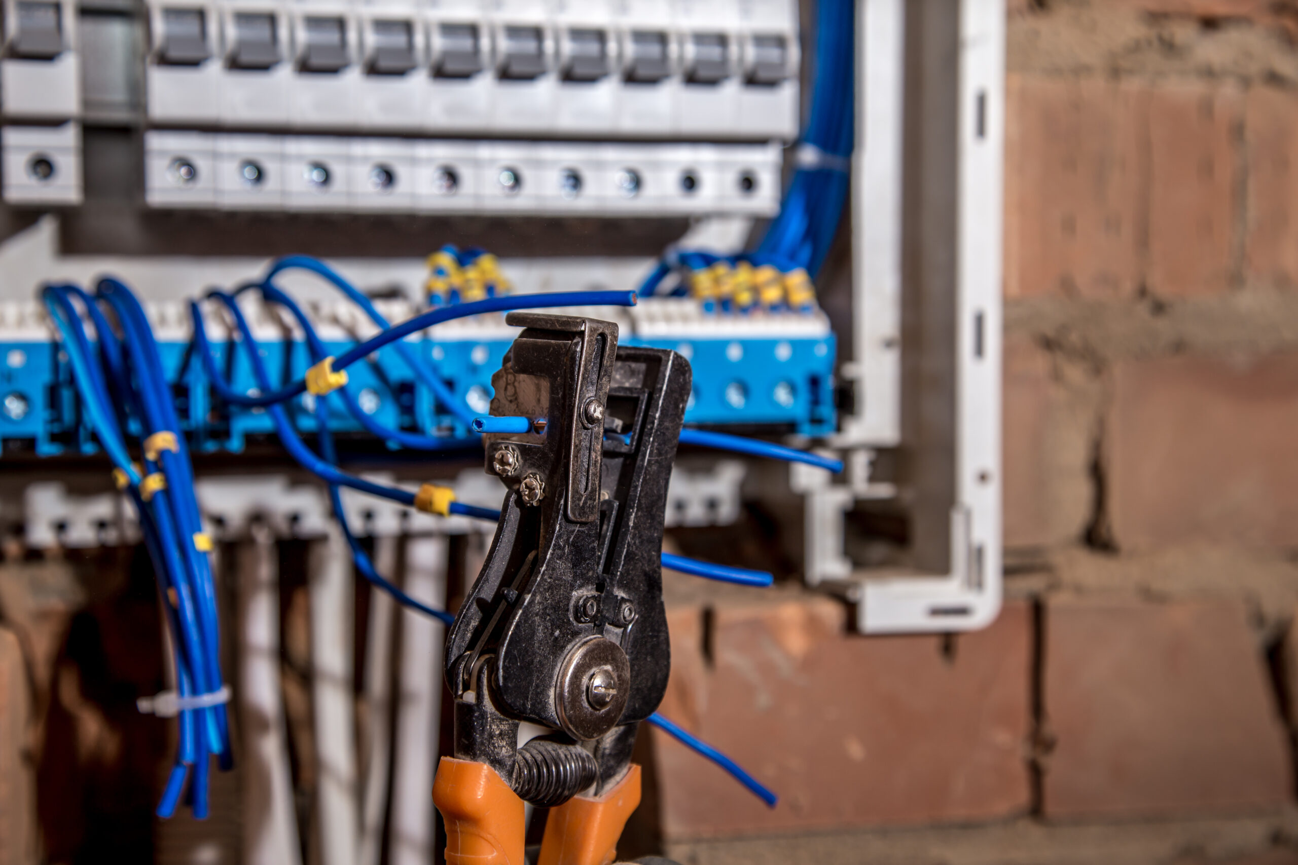 the Assembly of the electrical panel, electrician job, a robot with wires and circuit breakers, tools